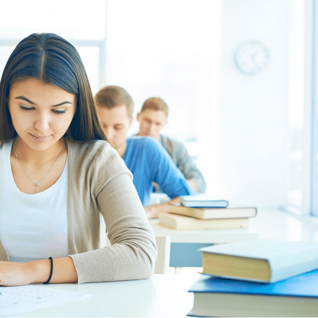 student doing an exam in a classroom